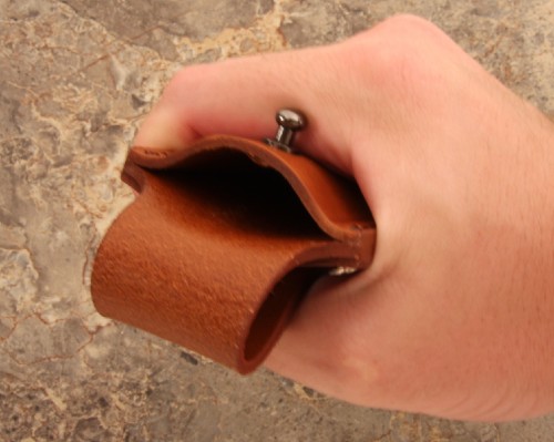 Squeezing a leather pouch to work it in